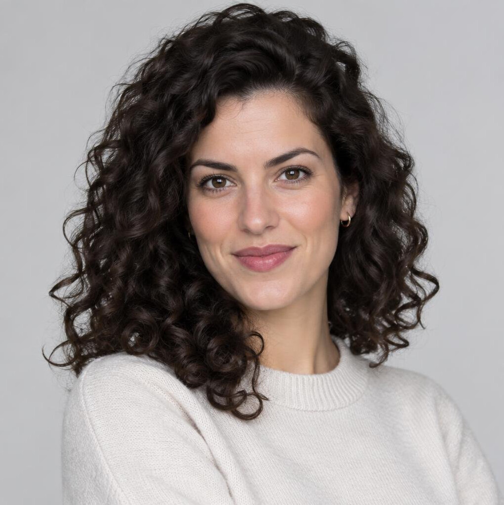 Studio portrait of a young woman with curly hair