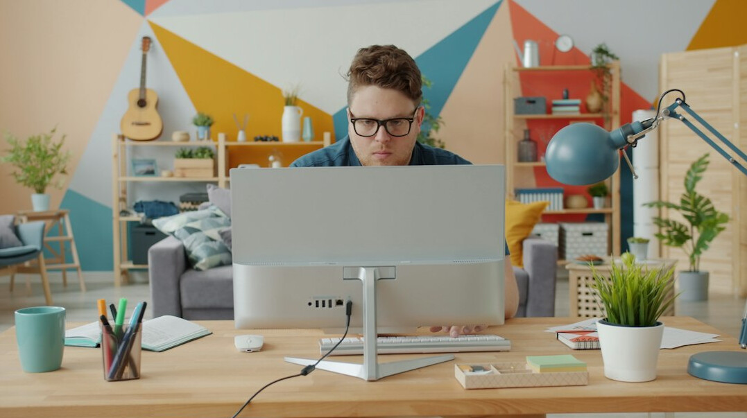 person coding at desk